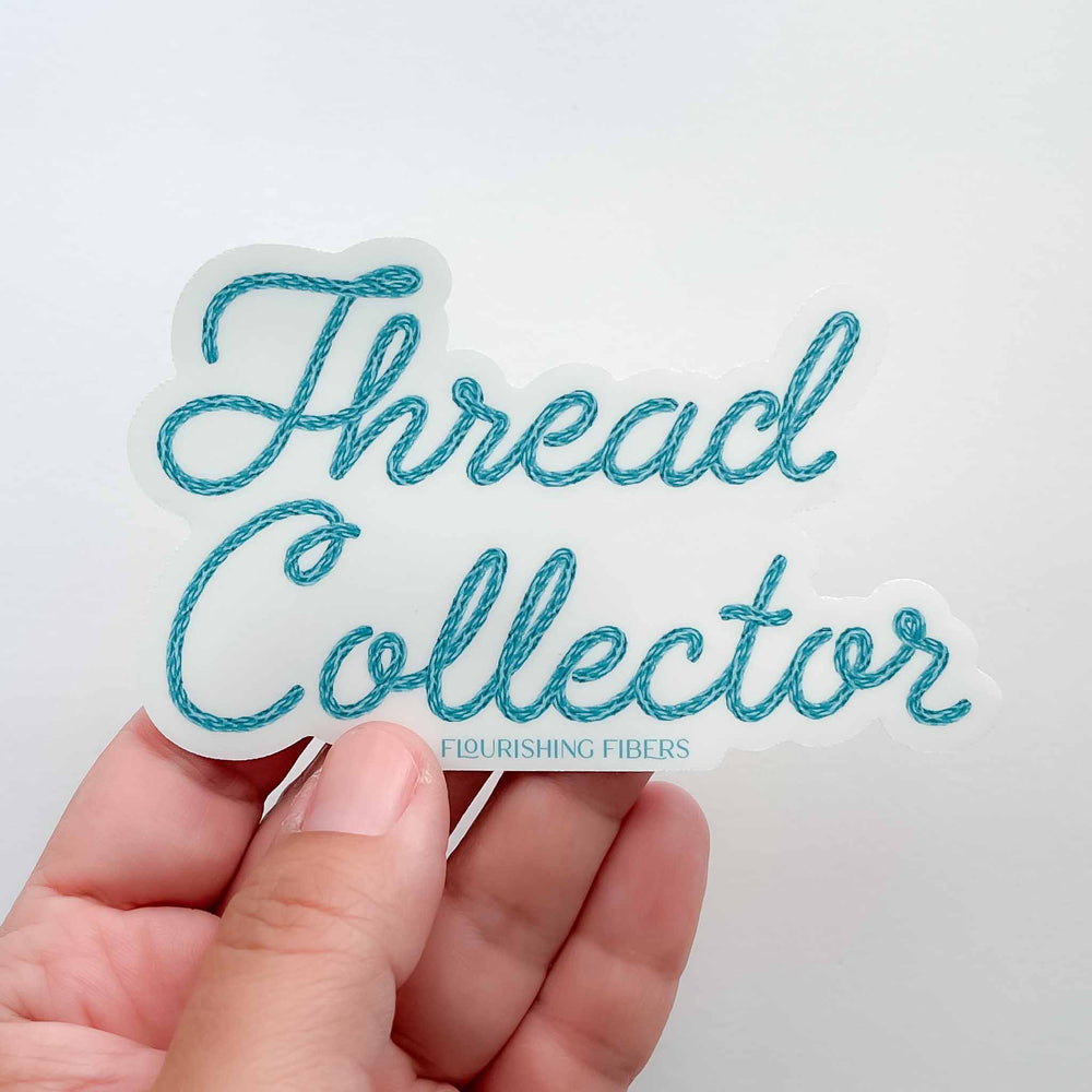 Sticker with 'Thread Collector' text held by a hand on a light background