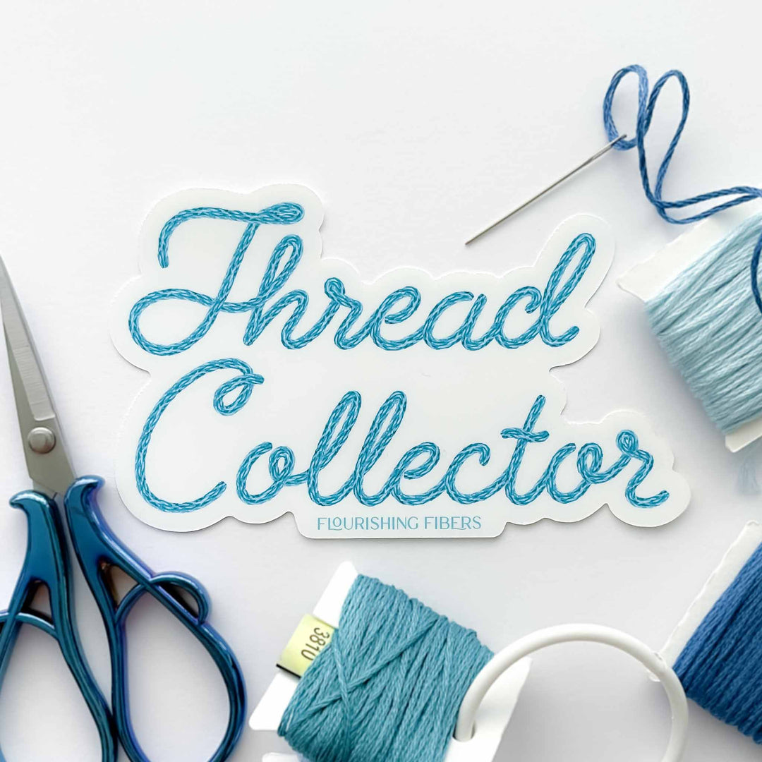 Sticker with 'Thread Collector' text surrounded by blue thread and scissors on a white background